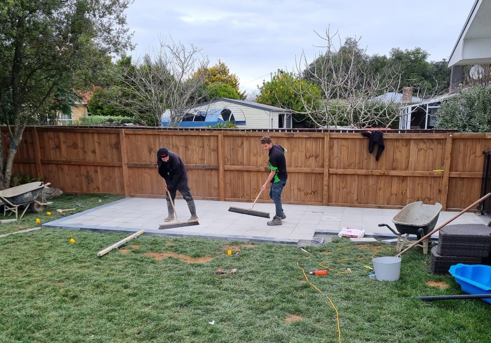 the auckland landscape company's team finishing off a paving job 
